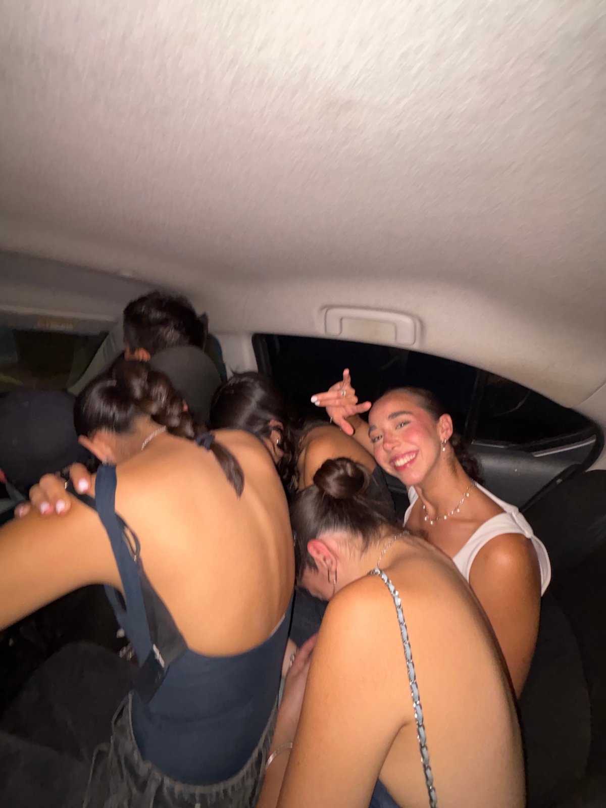 Young people gather together inside vehicle in friendly moment