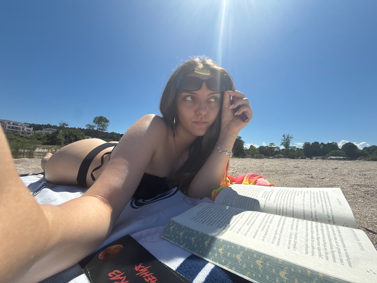 Woman enjoys quiet beach reading session in Tsarevo