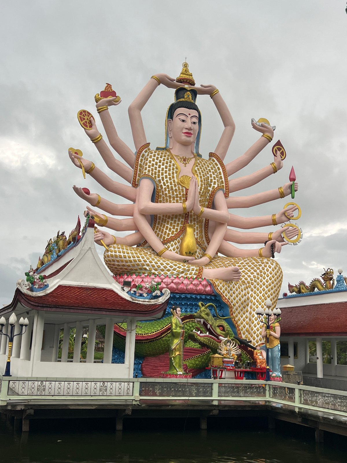 Tourist visits Wat Plai Laem temple complex in Thailand