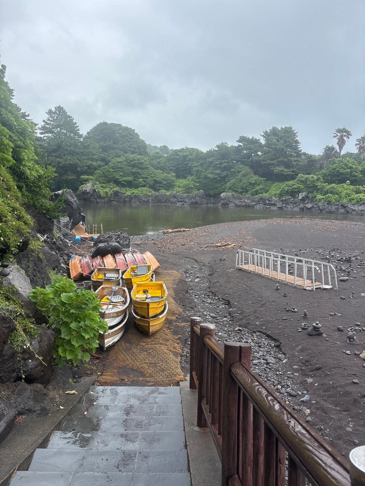 Rainy day along Seogwipo's volcanic coastline and black sand beaches
