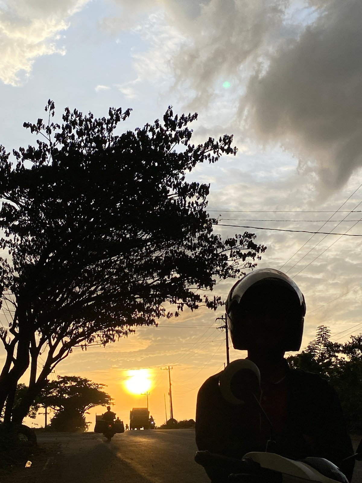 Sunset traffic on a Lhokseumawe road, golden hour silhouettes