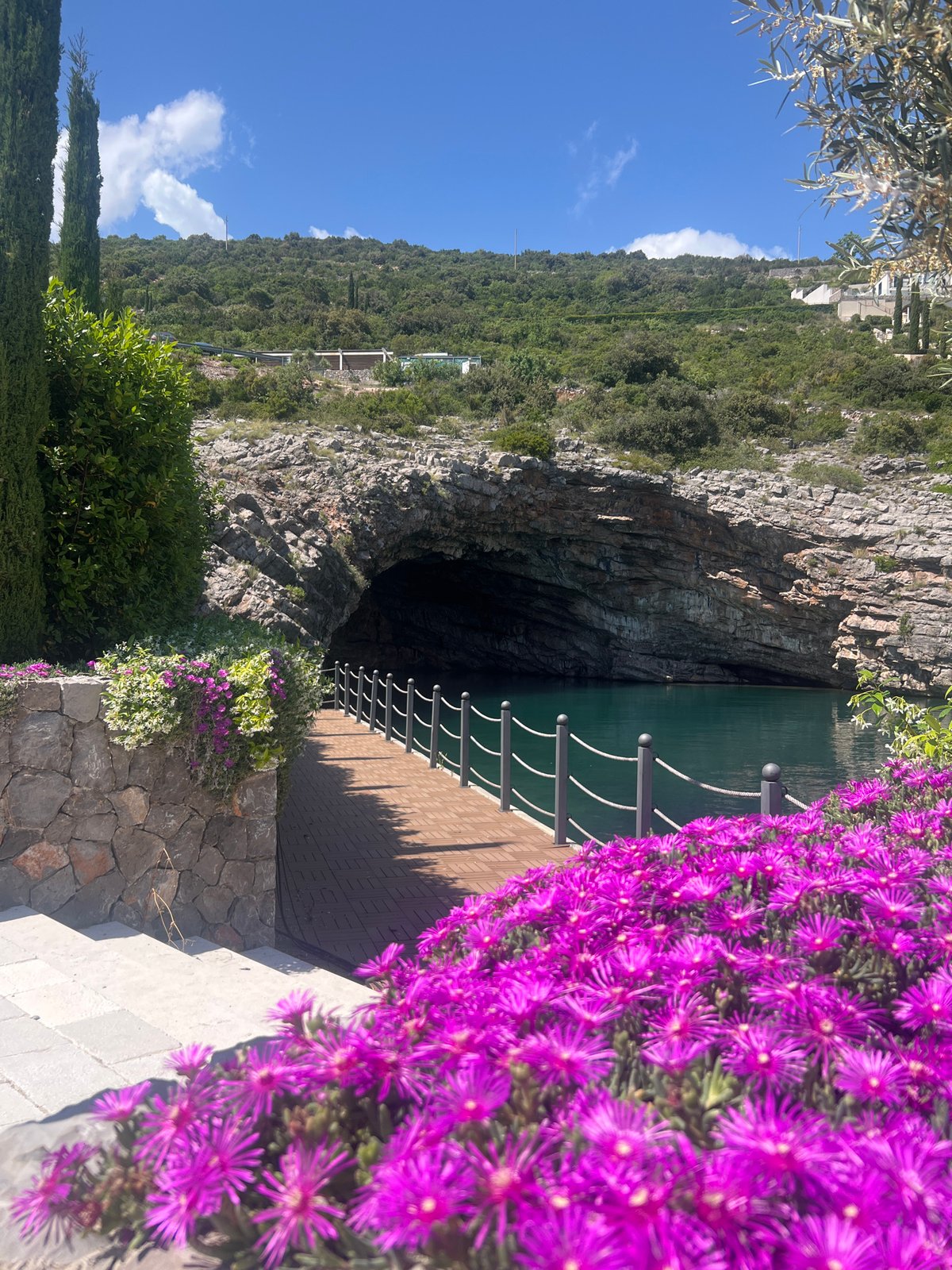 Tourist explores coastal caves and waterfront in Radovići, Montenegro