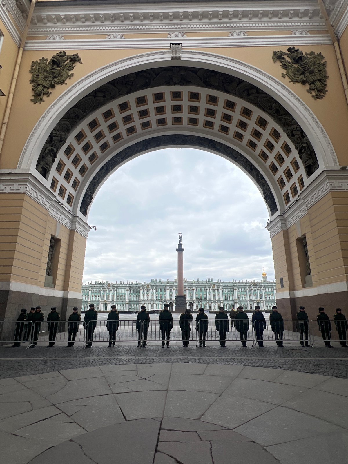 Tourist documents Palace Square architecture during overcast afternoon