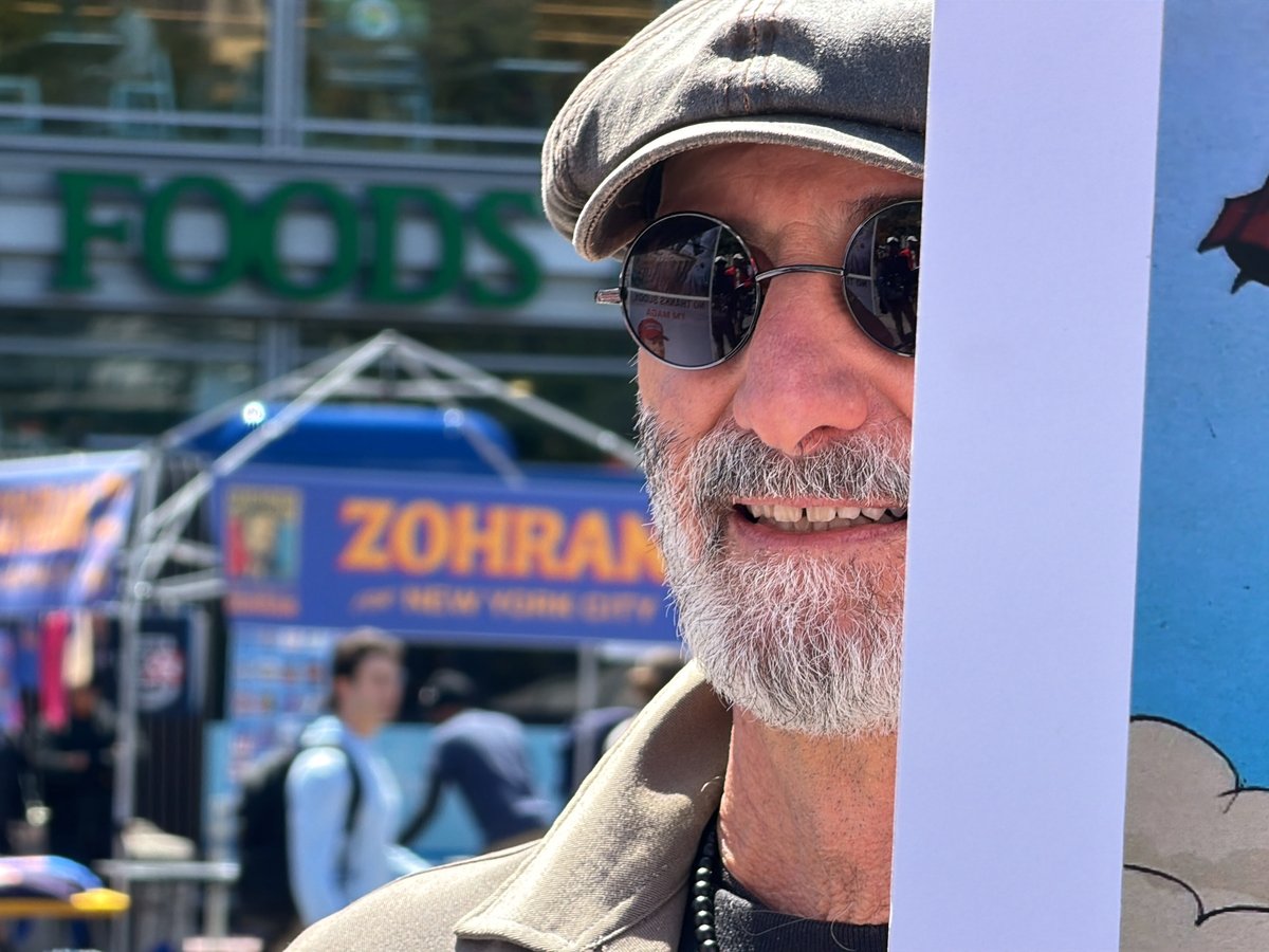 Street photography captures bearded man and ornate NYC building