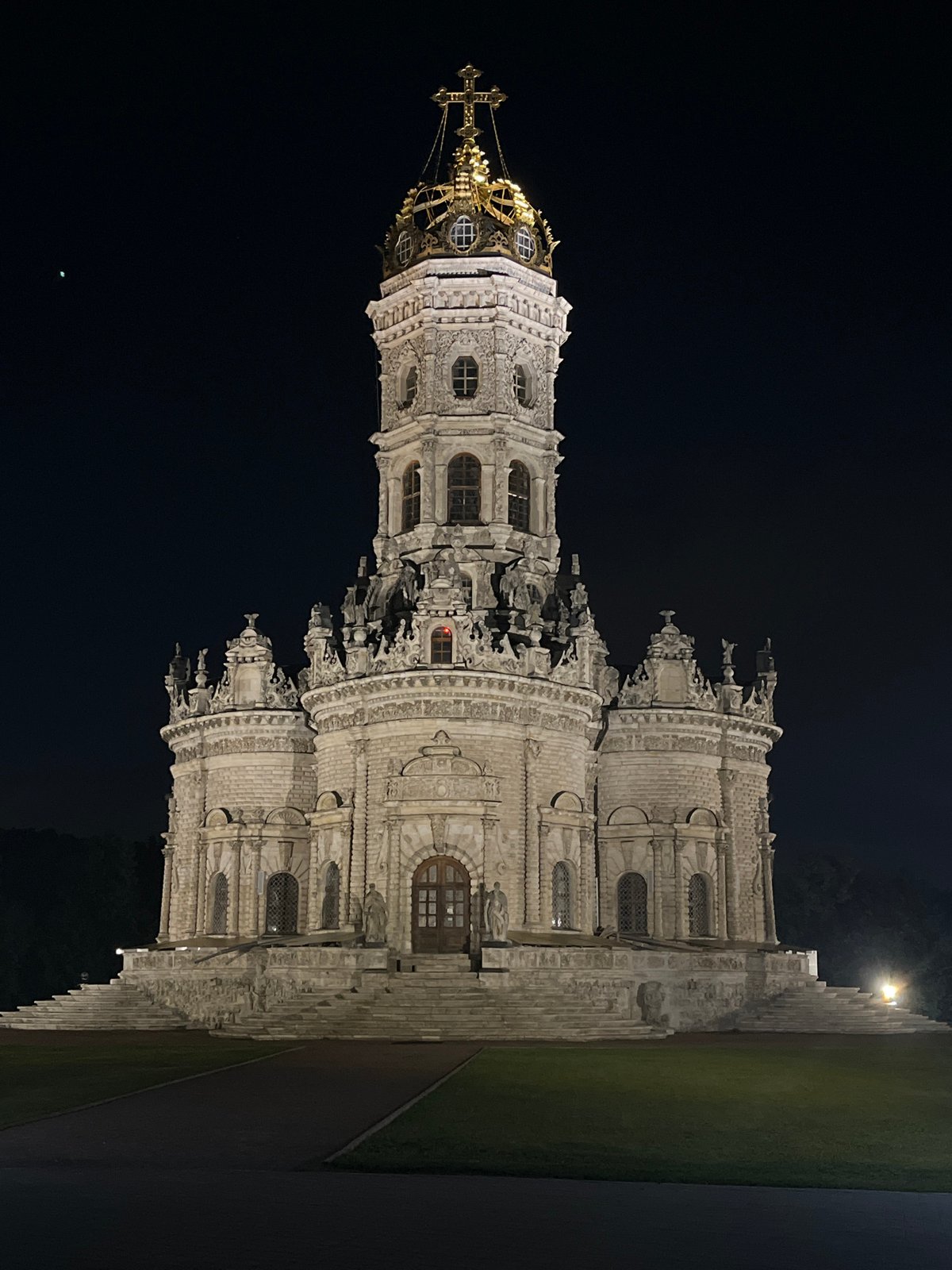 Nighttime stroll through lit baroque architecture and park paths