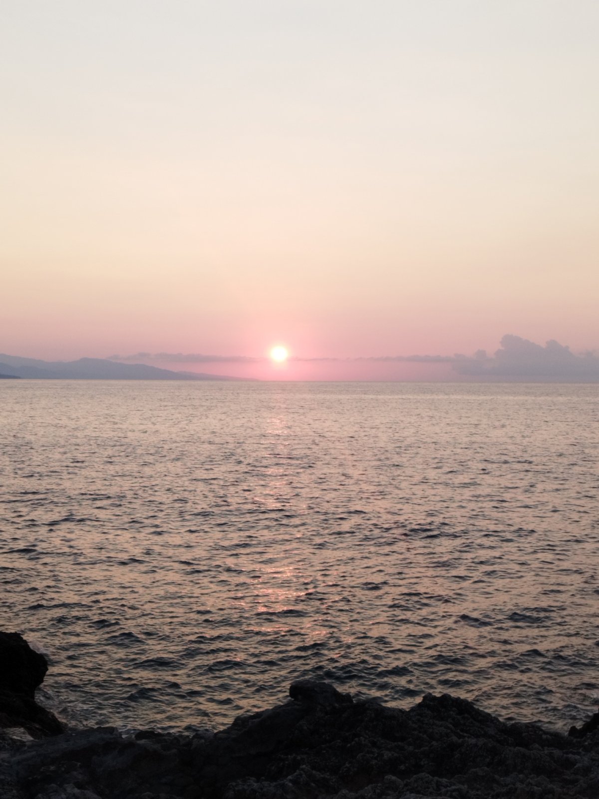 Sunset over the rocky Antibes coastline, July evening.