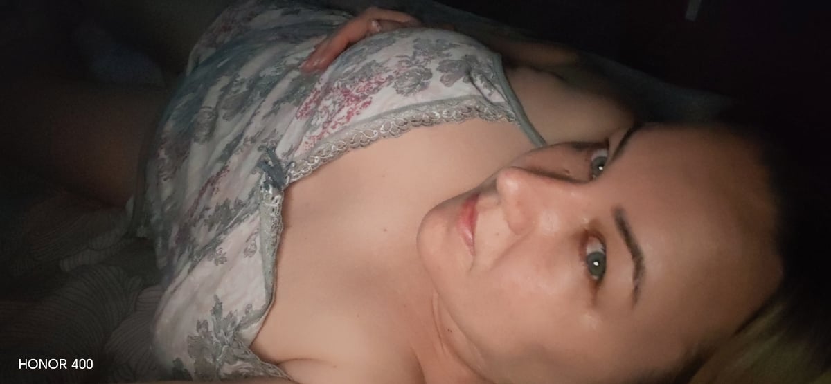 Woman photographed resting at home with pet dog in Russia
