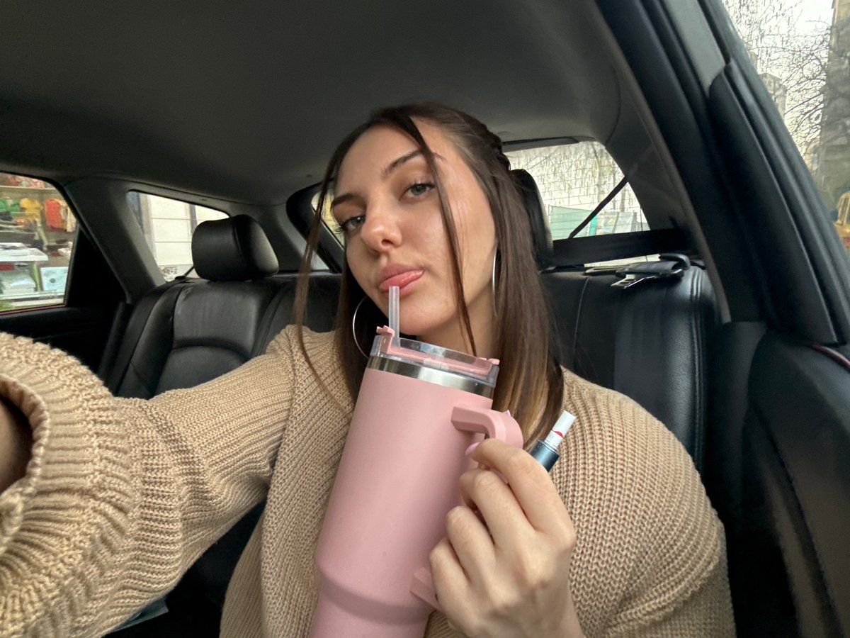 Woman with pink water bottle photographed in Sofia car