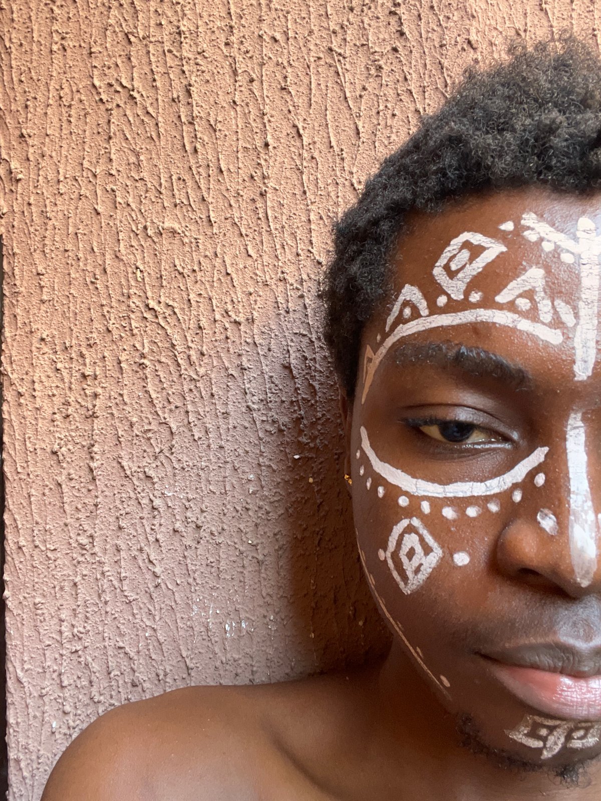 Person with traditional face paint photographed in Nkpor, Nigeria