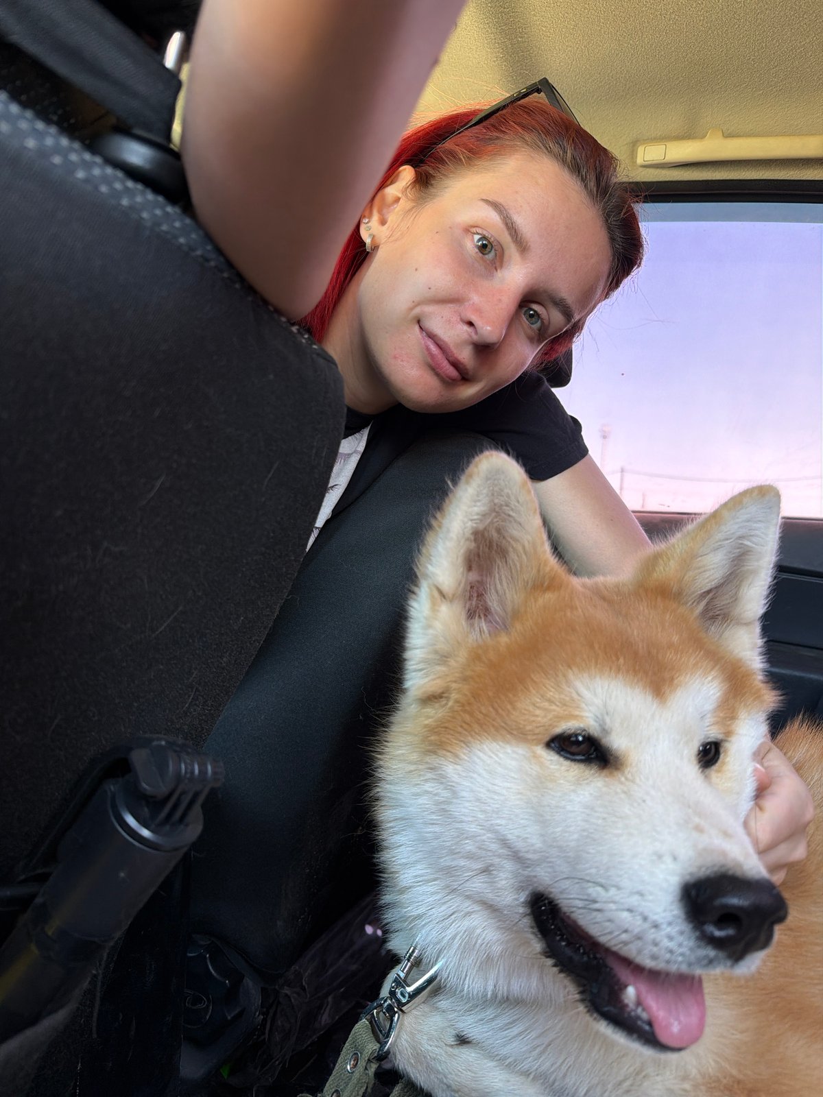 Woman takes selfie with Akita dog in Chaikovsky