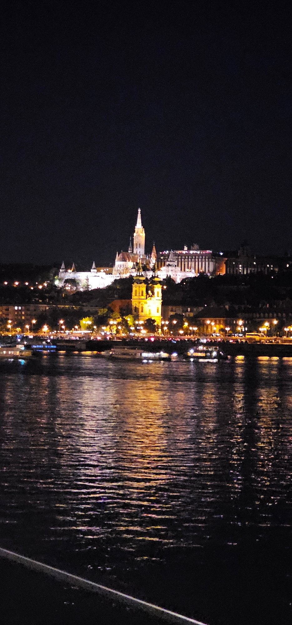 Danube River at night, Buda Castle District glowing behind it