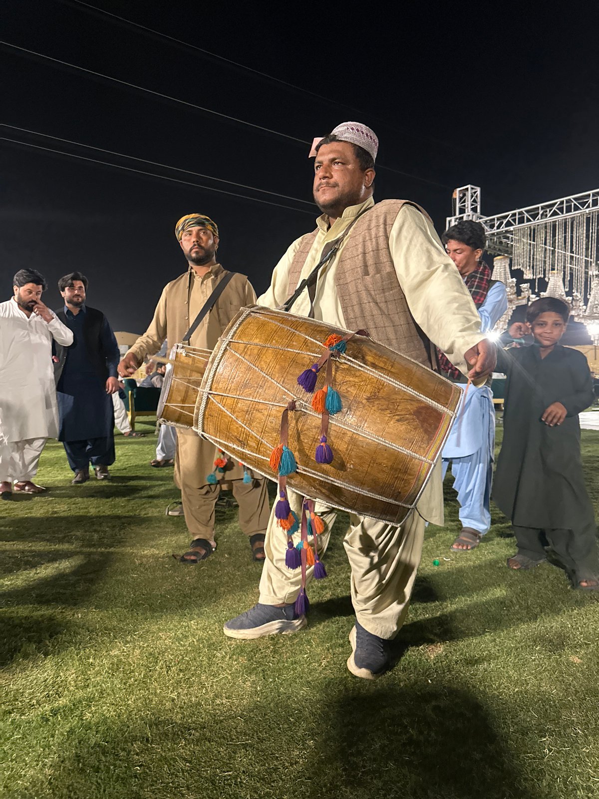 Traditional drumming performance at nighttime outdoor gathering