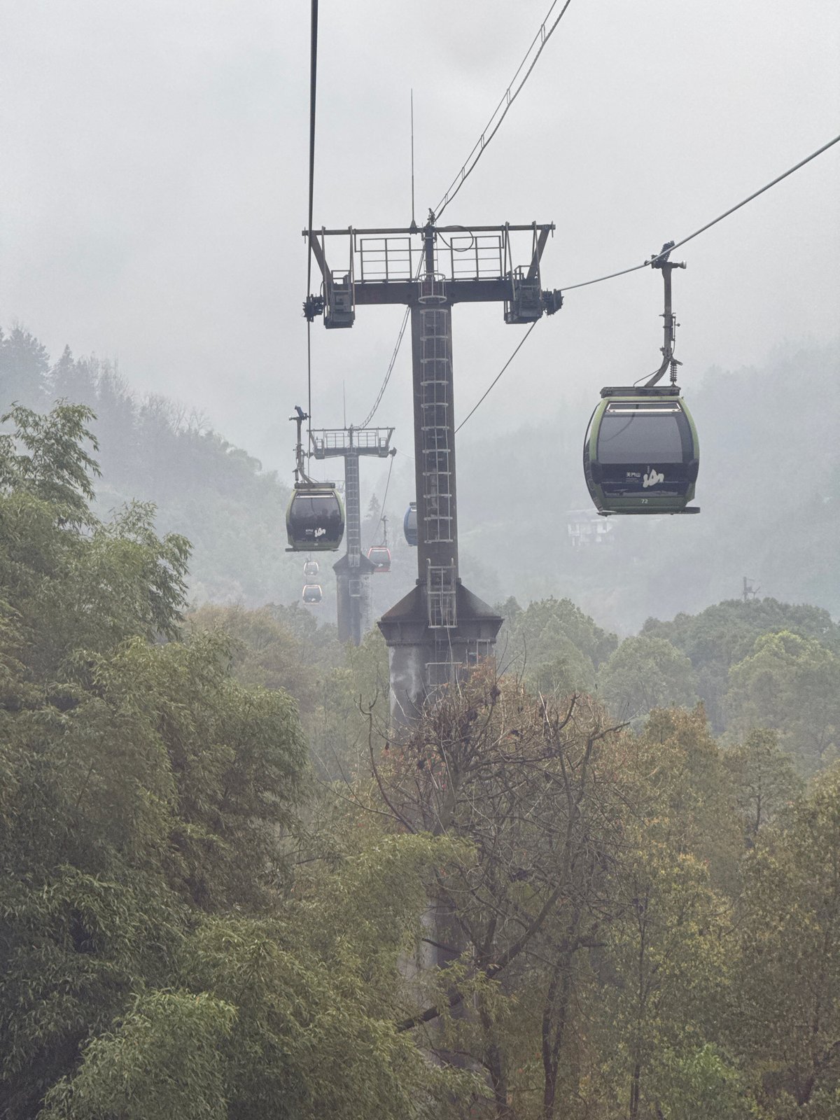 Cable cars operate through misty conditions at Tianmen Mountain