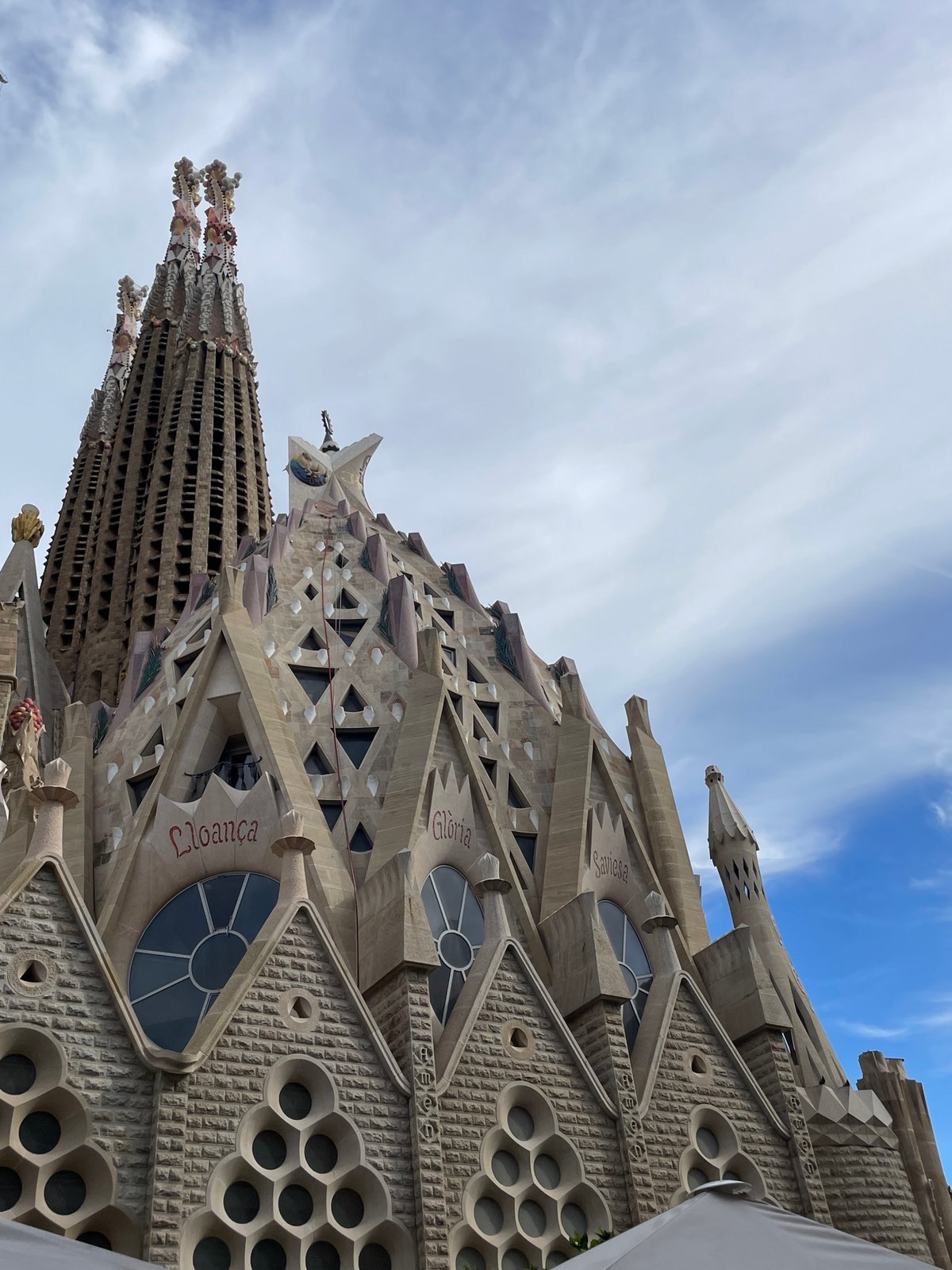 Tourist photographs Sagrada Familia's architectural details in Barcelona