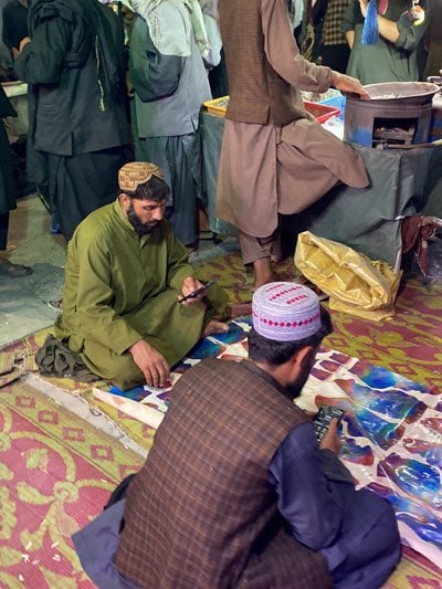 Nighttime street market bustles with activity in Kandahar