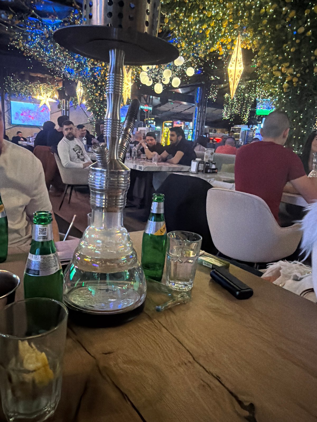 Evening dining scene documented at Sofia establishment with spring blooms