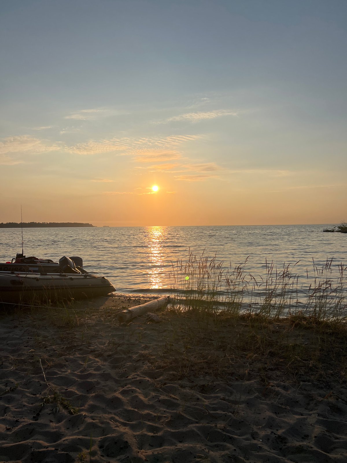 Golden hour at Lake Borovoe, boats ashore at sunset