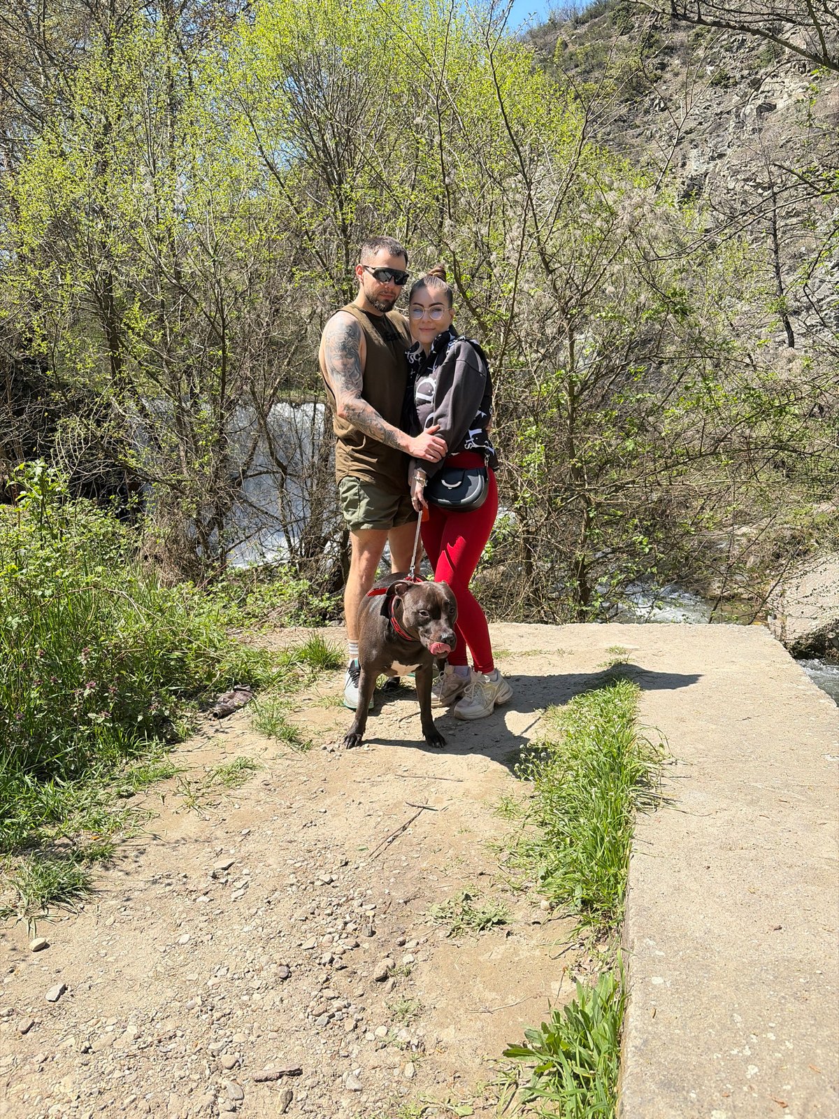 Couple explores scenic ravine area with dog in Parvenets