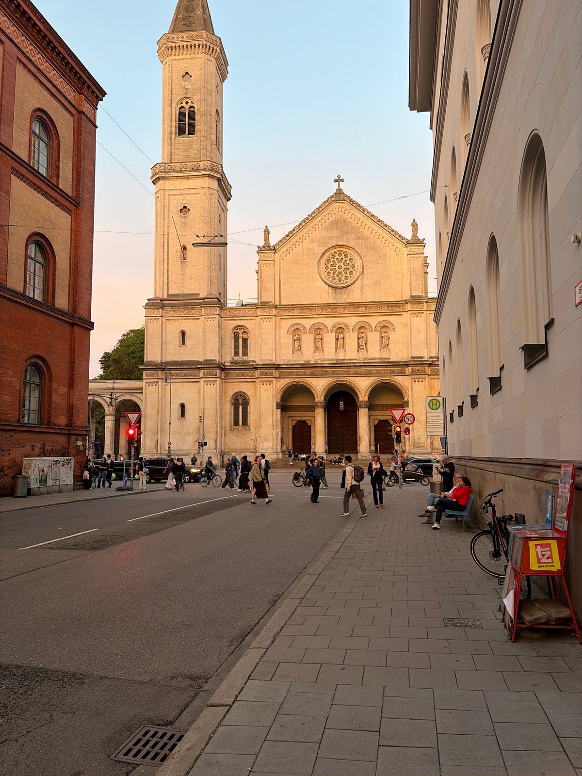 Munich street at golden hour, church and city buildings