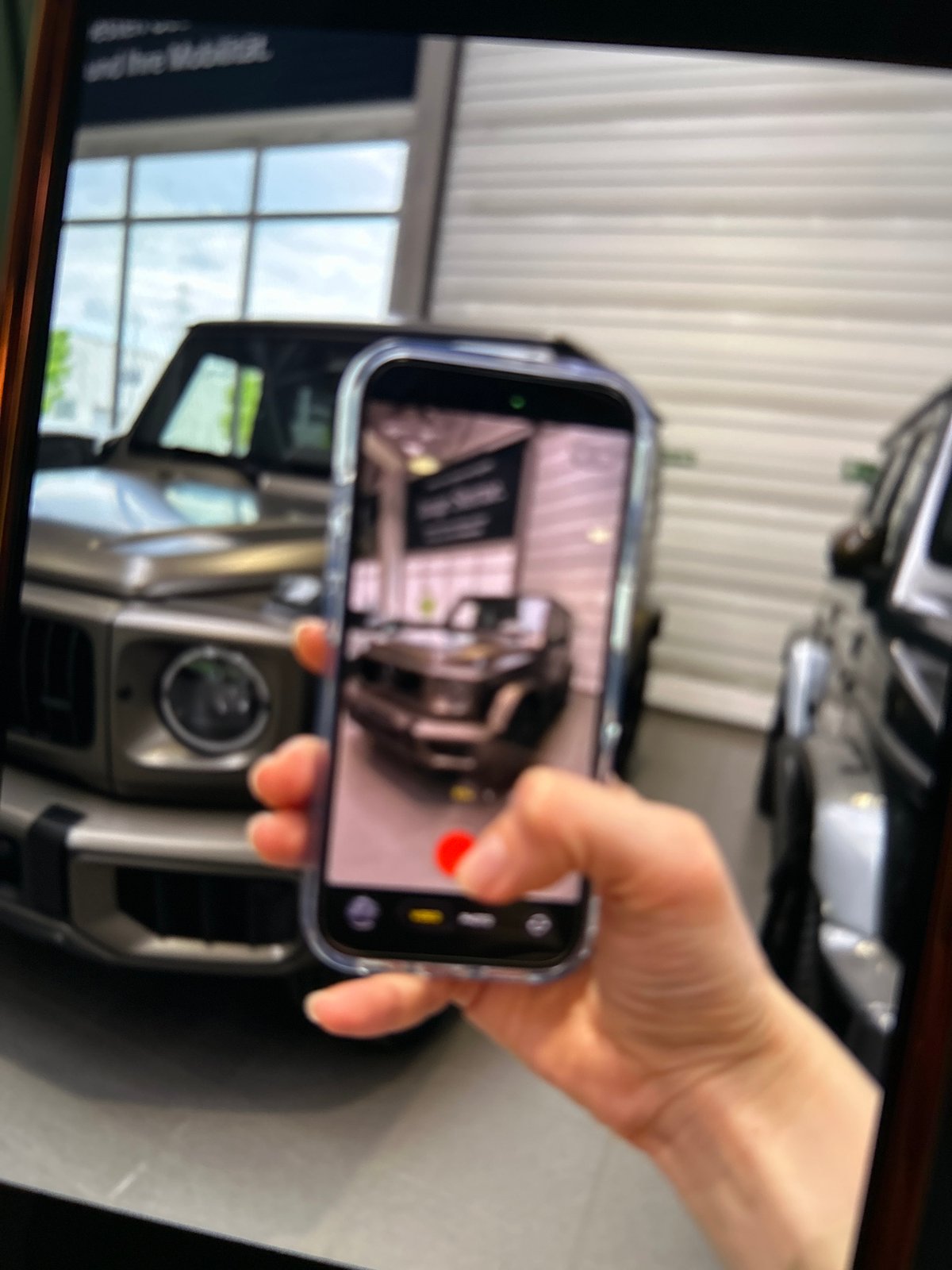 Person photographs Mercedes G-Class at German dealership
