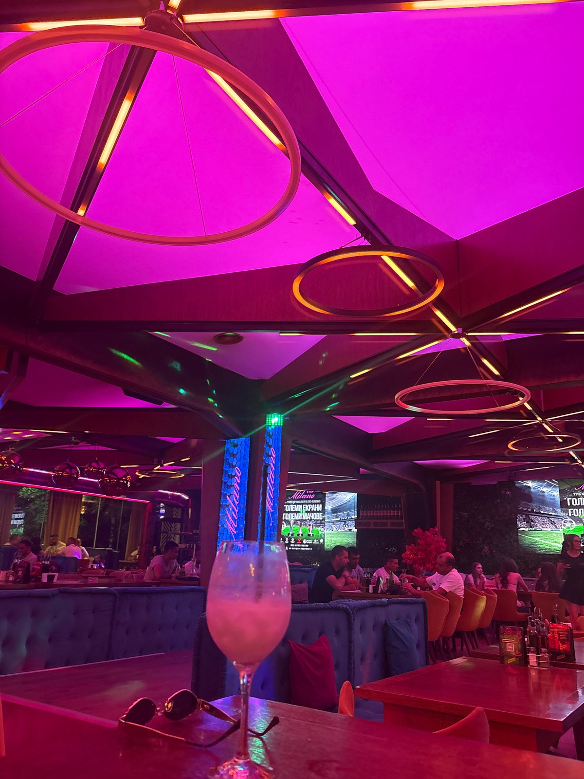 Evening nightclub interior documented with vibrant neon lighting displays