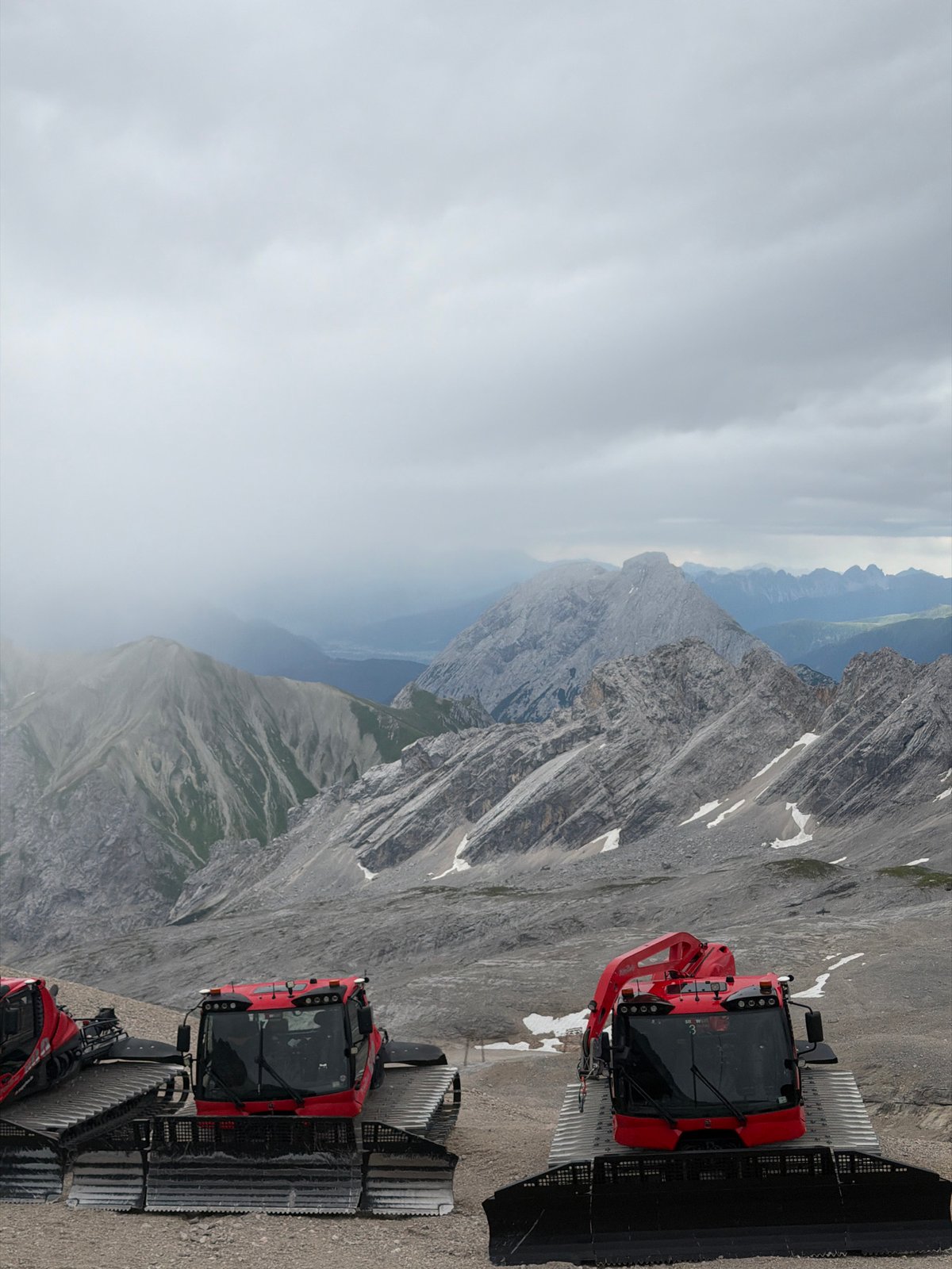 Zugspitze summit: snow groomers, church, and summer clouds