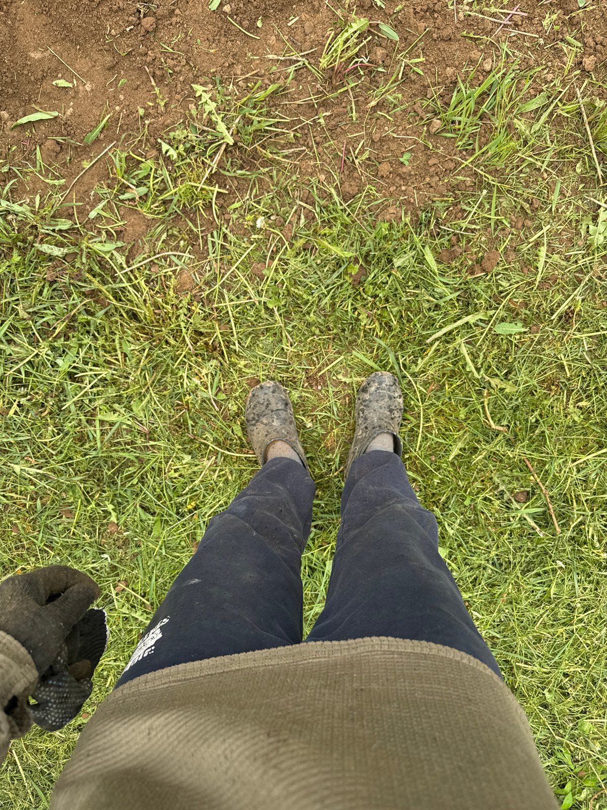Rural garden work documented in Russian village under overcast skies