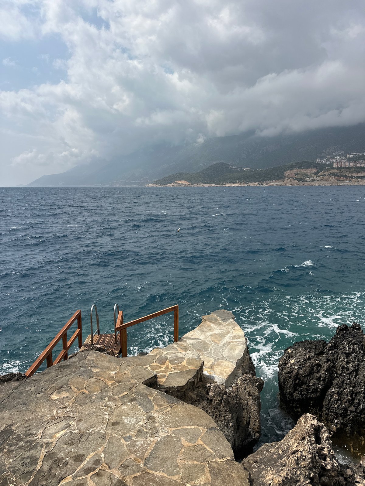 Empty beach furniture awaits visitors at Kaş coastal terrace