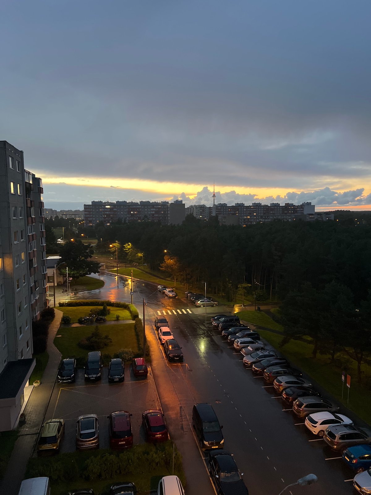 Tallinn residential district glows under a moody summer dusk sky