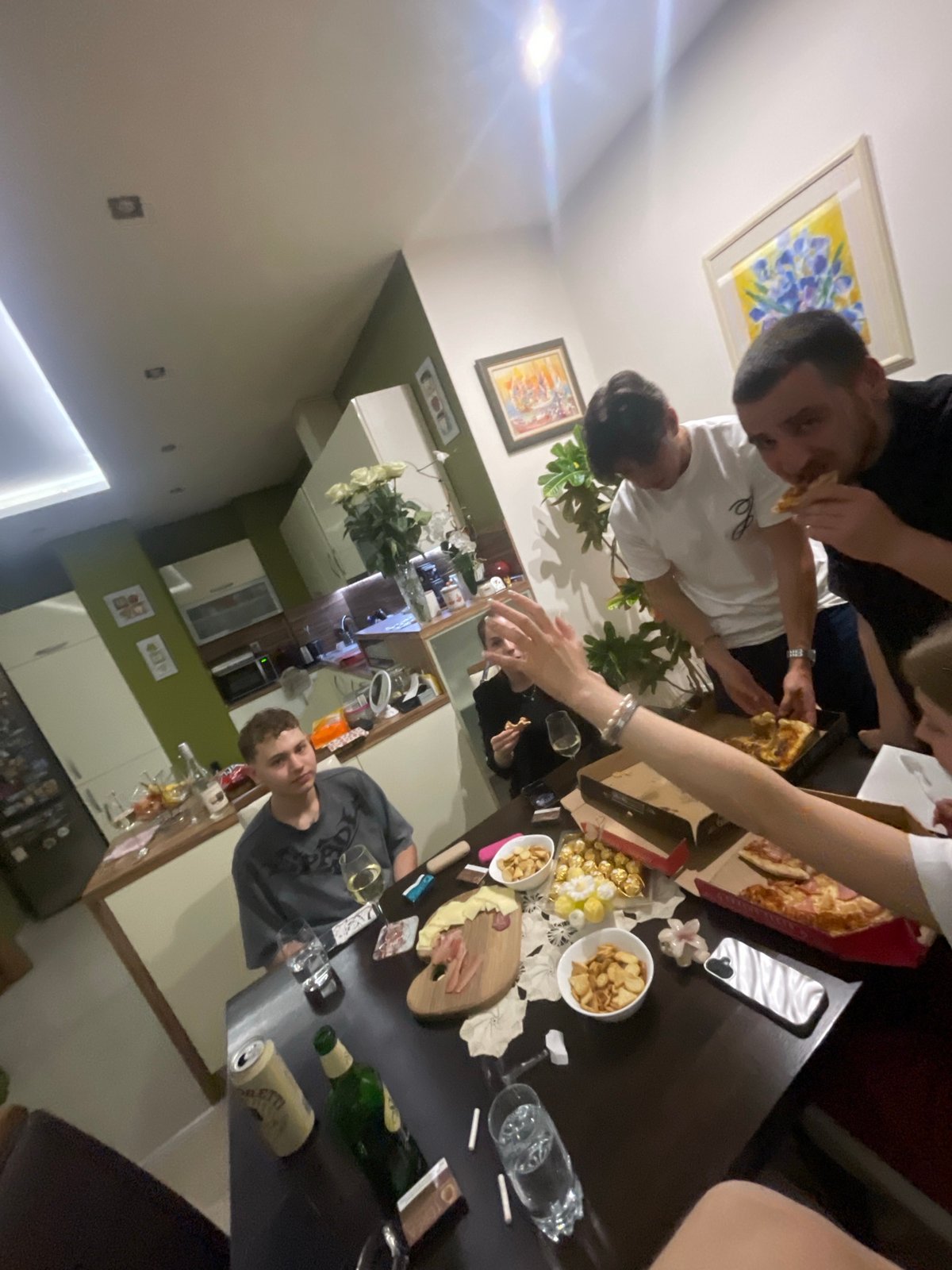Indoor scenes captured in Varna: gathering, skateboard collection, woman with cat