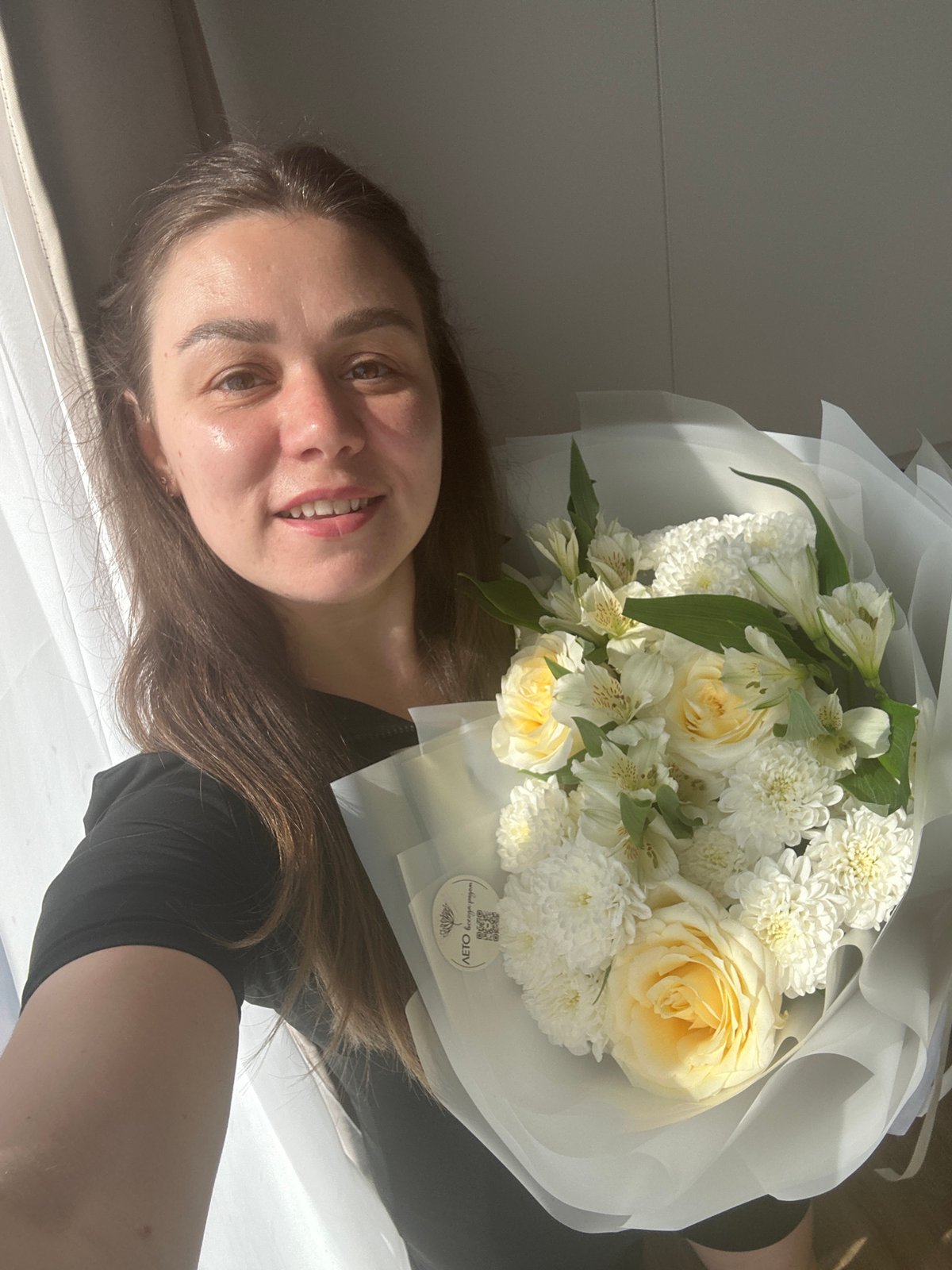 Posing with fresh flower bouquets at home in Chaikovsky