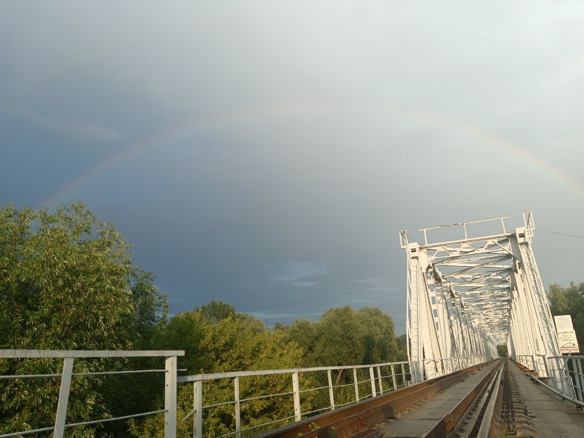 White steel railway bridge with twin tracks, rural Belarus