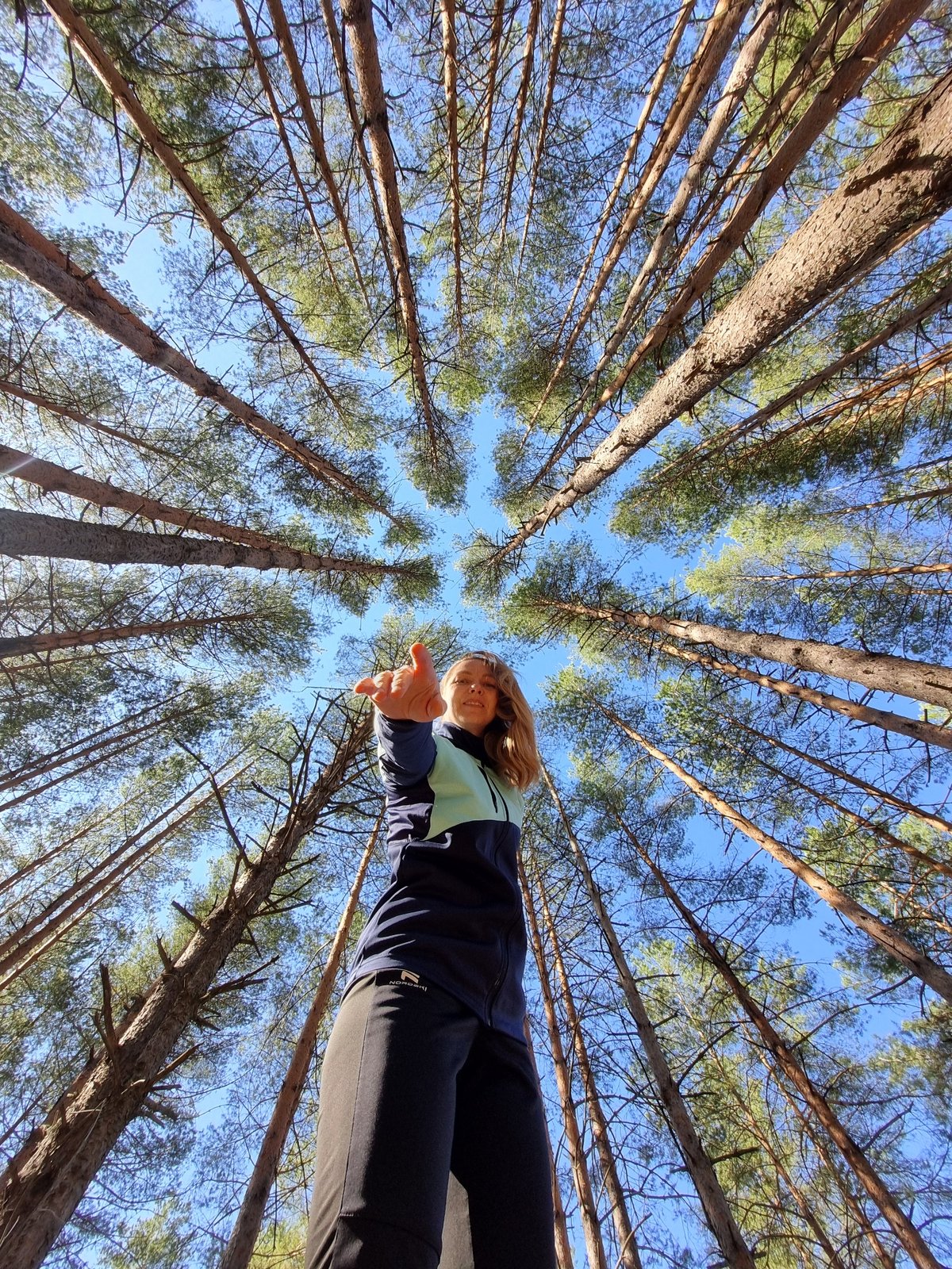 Woman photographed in pine forest during morning in Chaikovsky