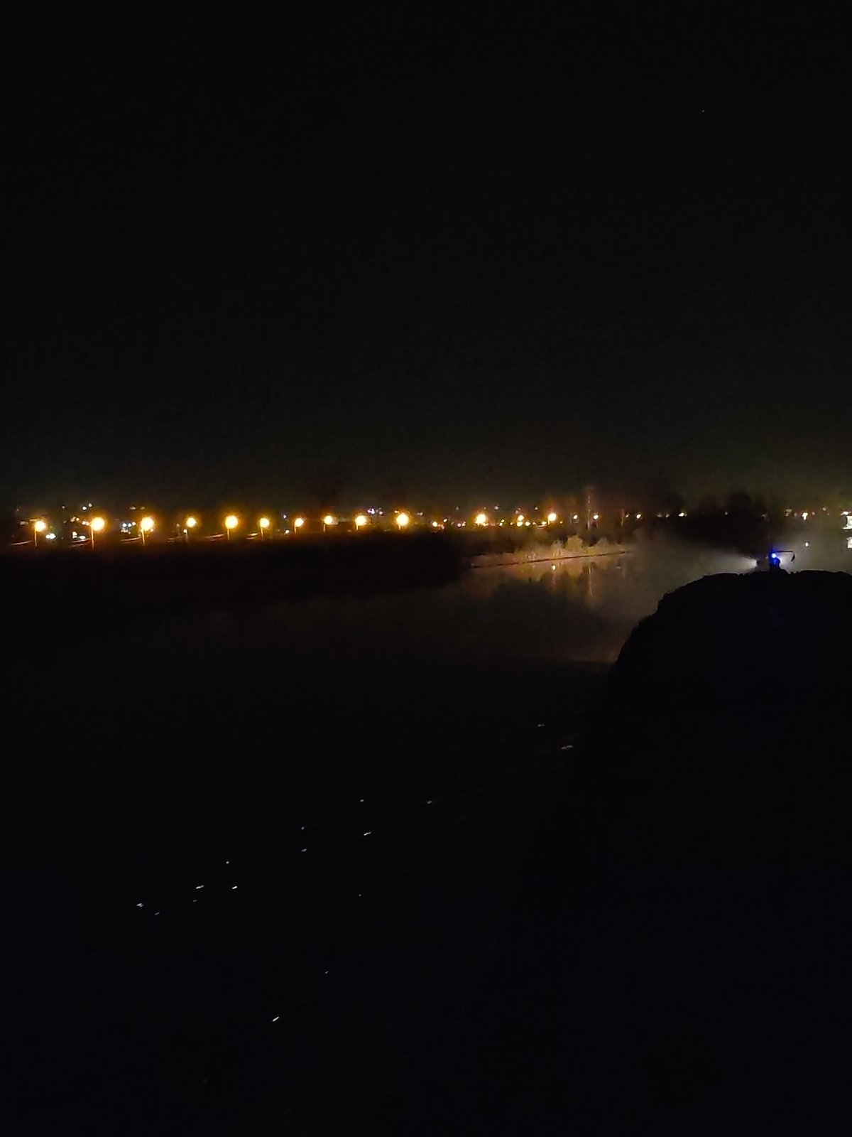 Nighttime streetlights illuminate waterfront in Yakhroma, Russia