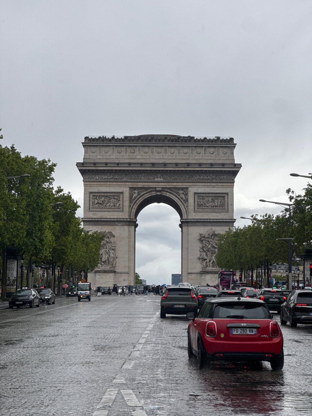 Wet streets and heavy traffic near Arc de Triomphe