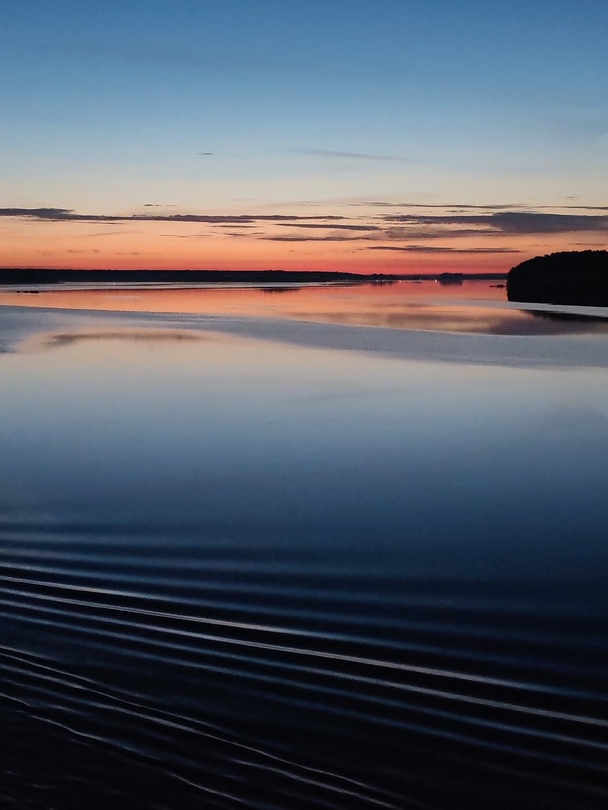 Twilight colors captured over still waters in Nova, Russia