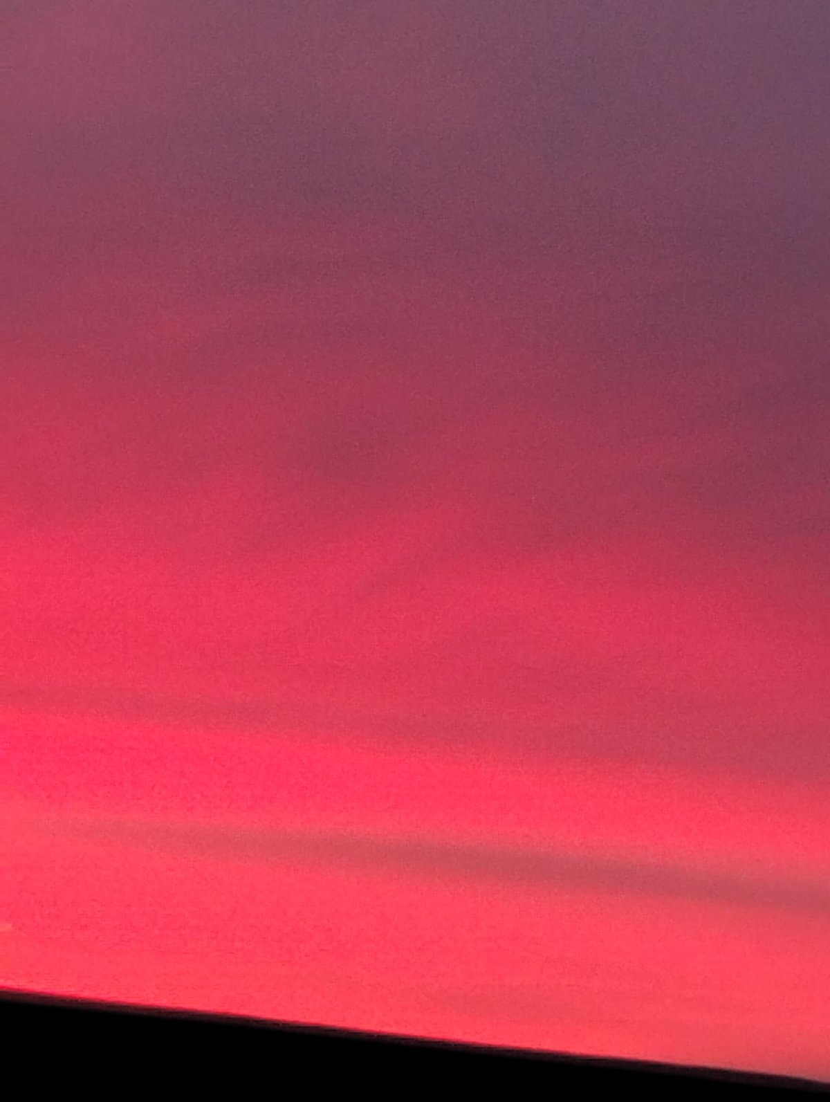 Dramatic red-pink sky gradient observed in Krasnogorskoye, Russia