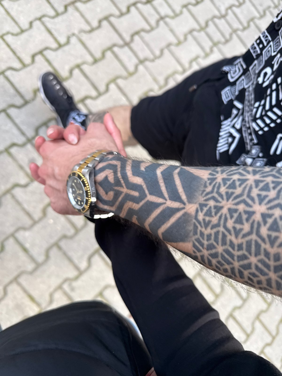 Two people hold hands in outdoor Sofia setting