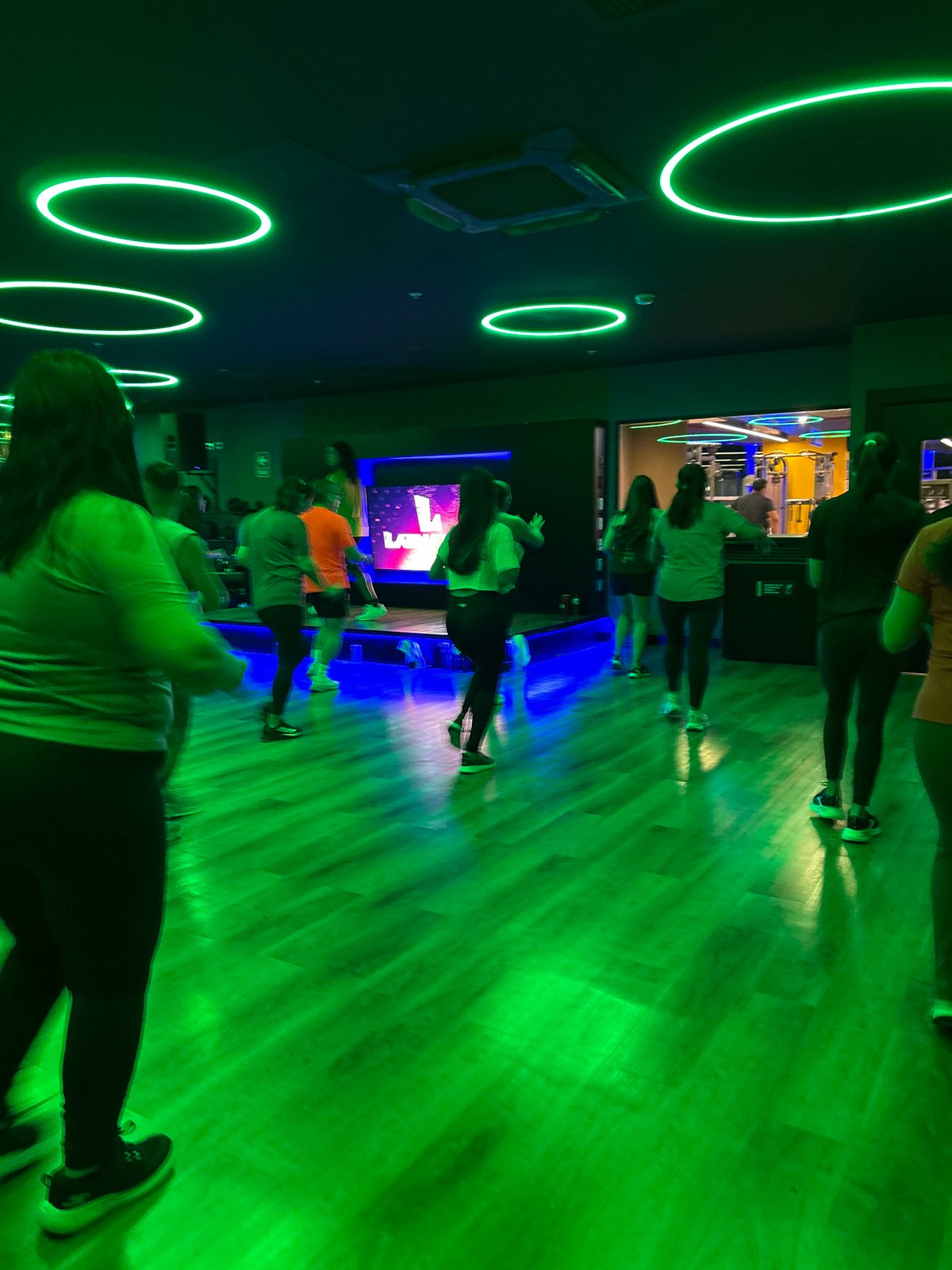 Dance fitness class at a neon-lit San Isidro gym