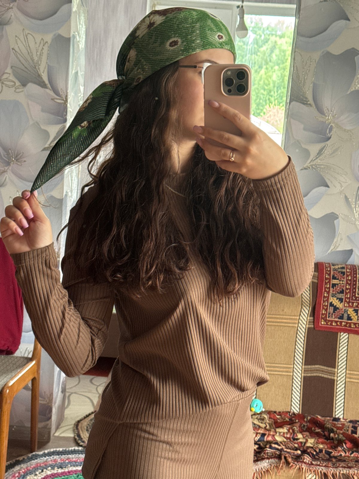 Woman takes selfies in room in Nizhnyaya Gar', Russia