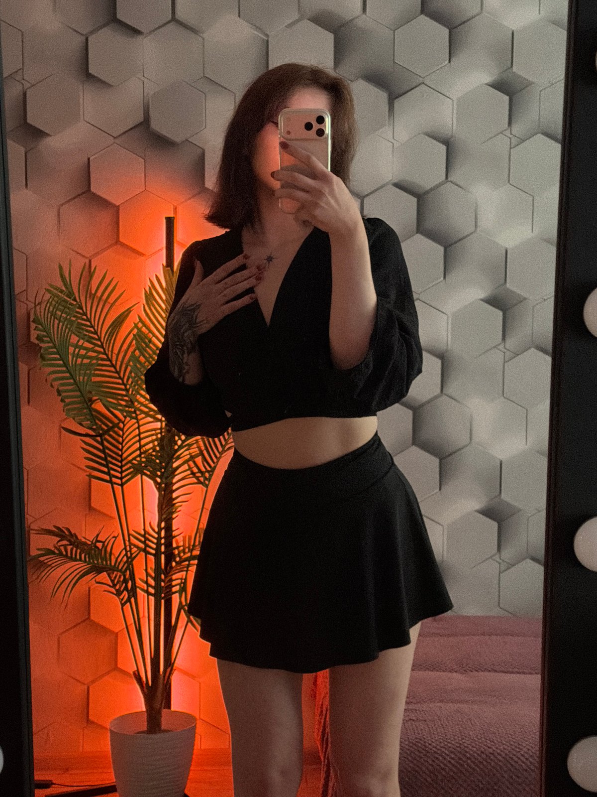Person takes multiple selfies while gaming in decorated room