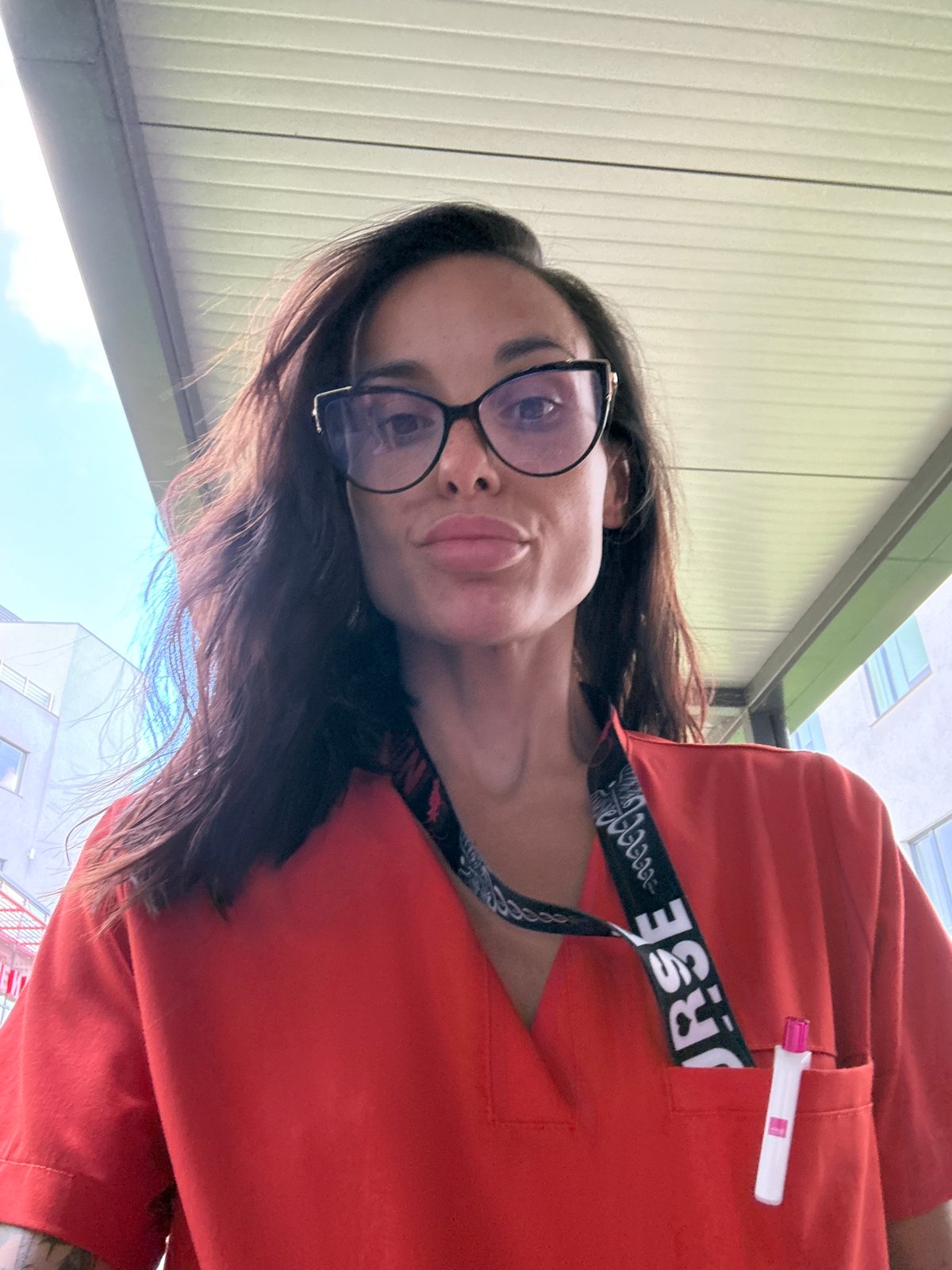 Nurse in orange scrubs photographed outdoors in Pleven, Bulgaria