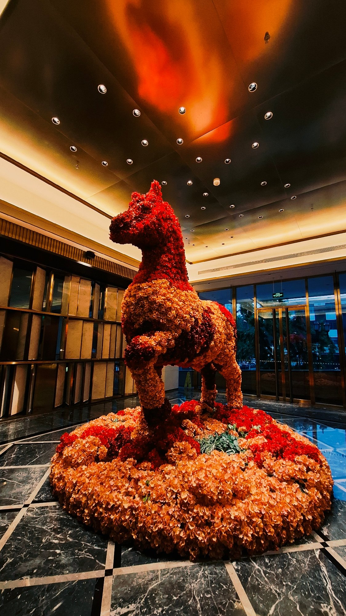 Floral horse sculpture observed in Beijing building interior