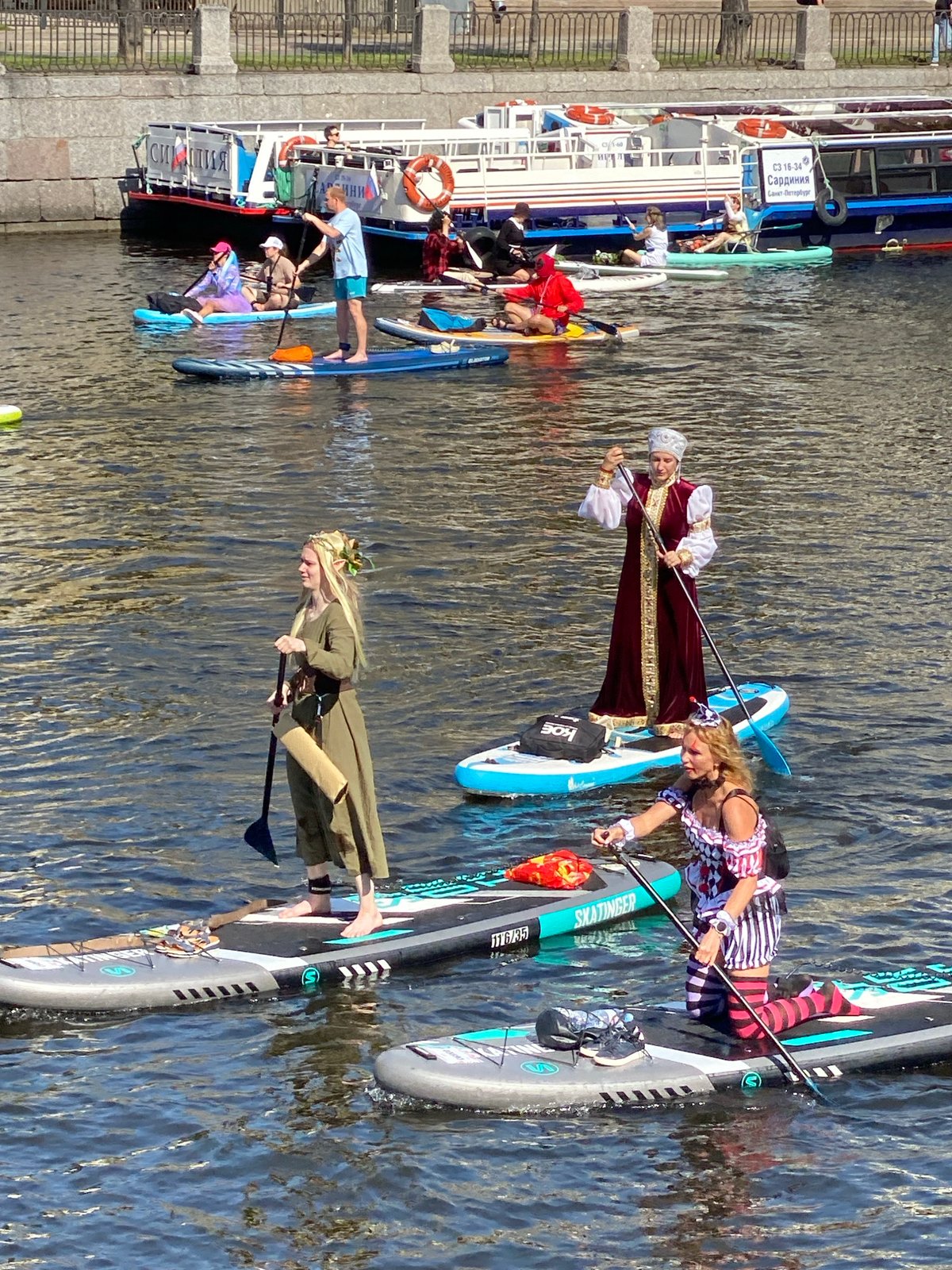 Costumed paddleboard procession through Saint Petersburg's canals