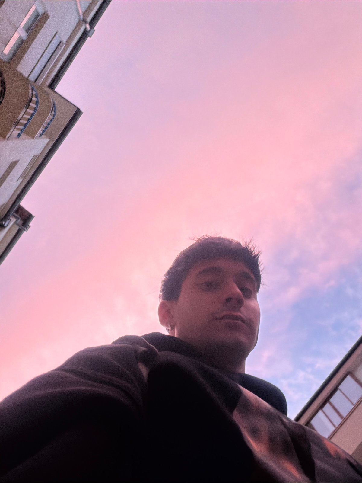 Young person photographed against dramatic twilight sky in Blagoevgrad