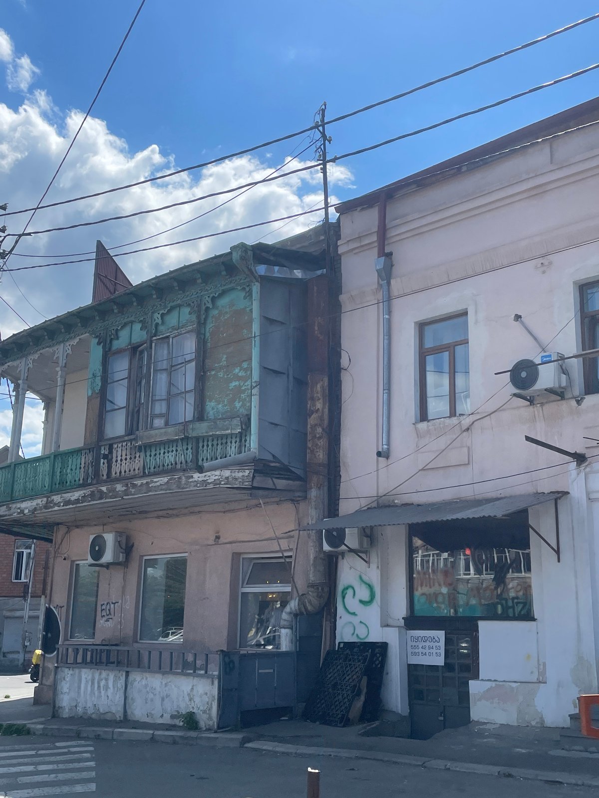 Street life and architecture across a sunny Tbilisi afternoon