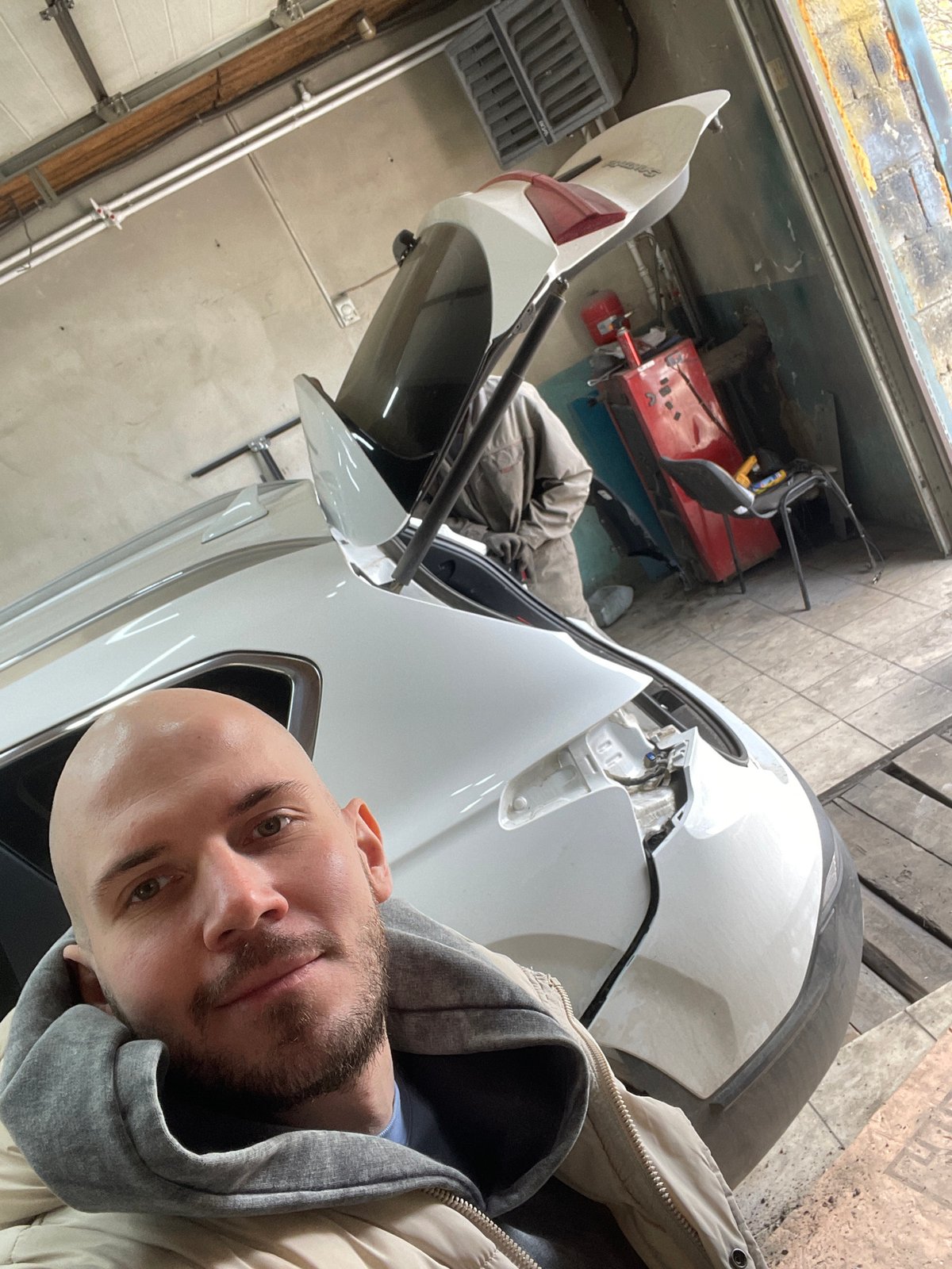 Man takes selfie in garage workshop in Minino, Russia