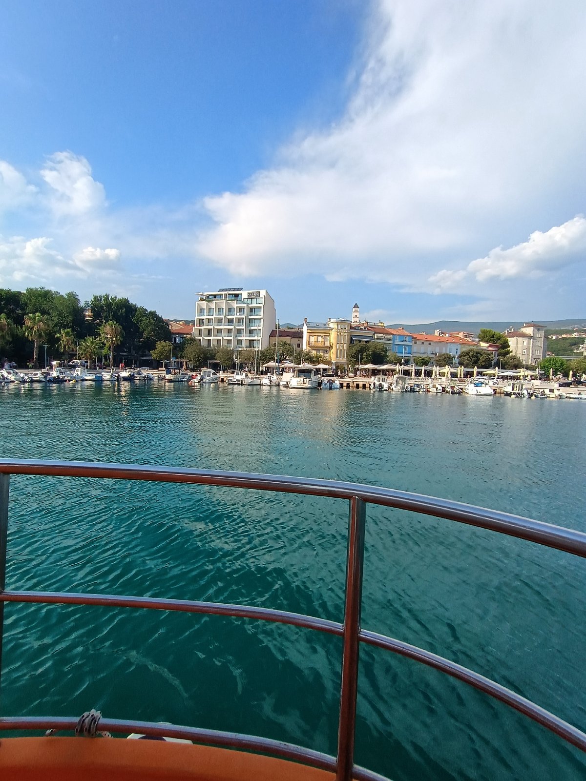 Crikvenica harbor on a summer afternoon, Ferris wheel and boats