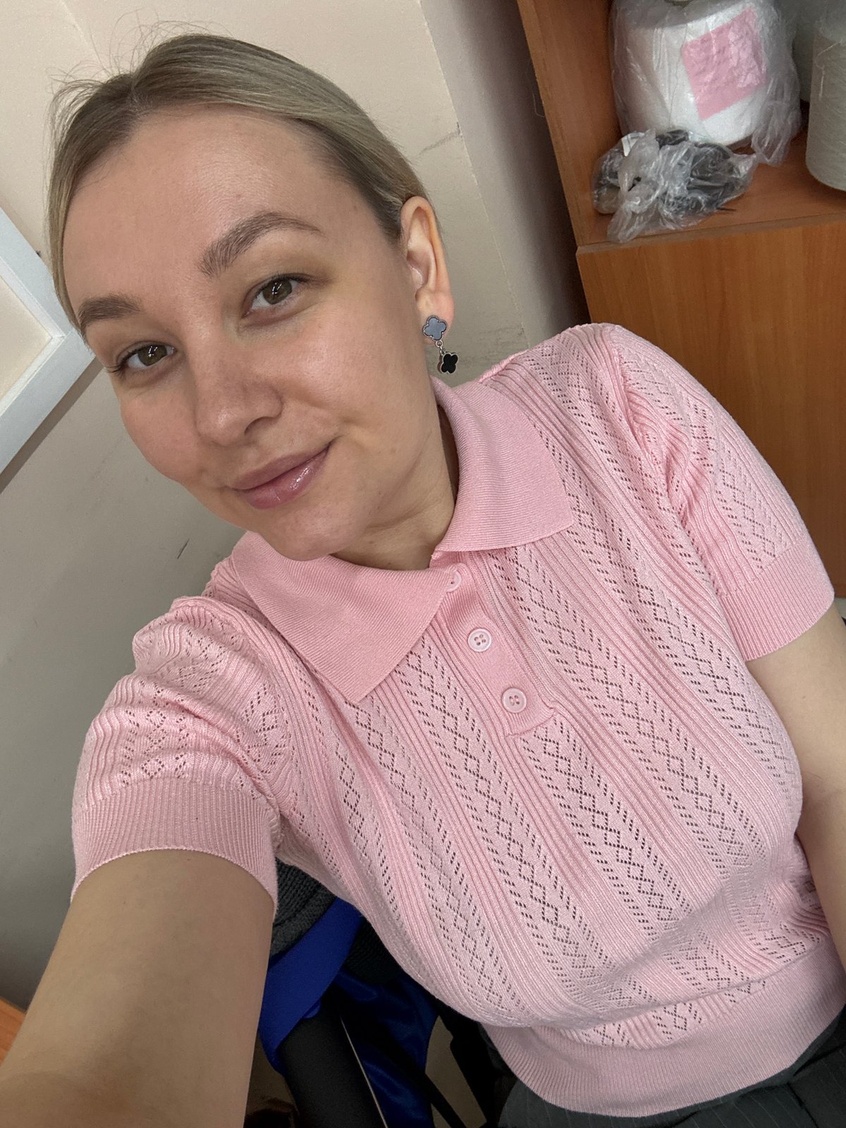 Woman takes selfie in pink knit top in Chaikovsky