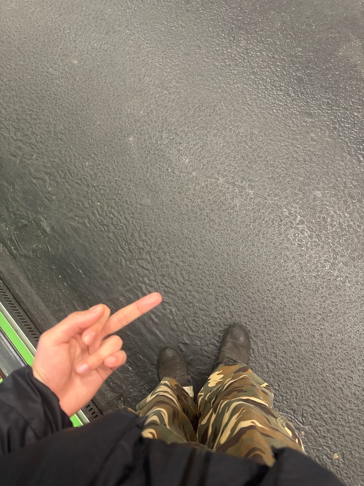 Two people make hand gestures at Paris metro platform
